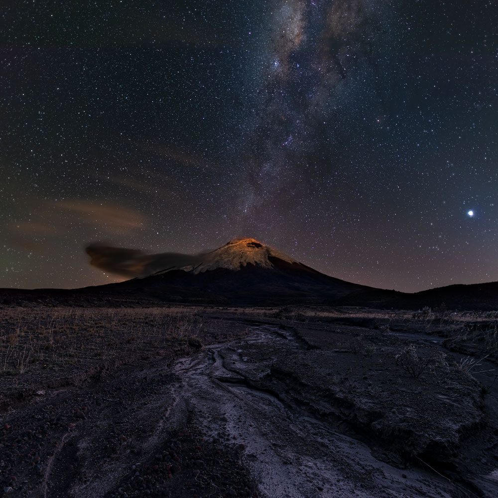 Nightscape photography of the Cotopaxi volcano crowned by the milky way