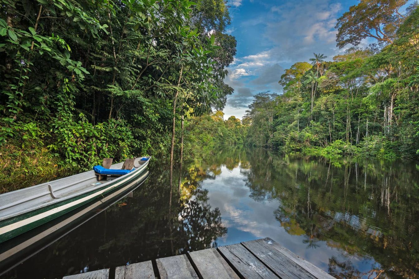 Photography of the Cuyabeno river with pontoon and canoe